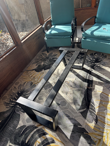 The base has two trapezoidal ends, and long bars between them